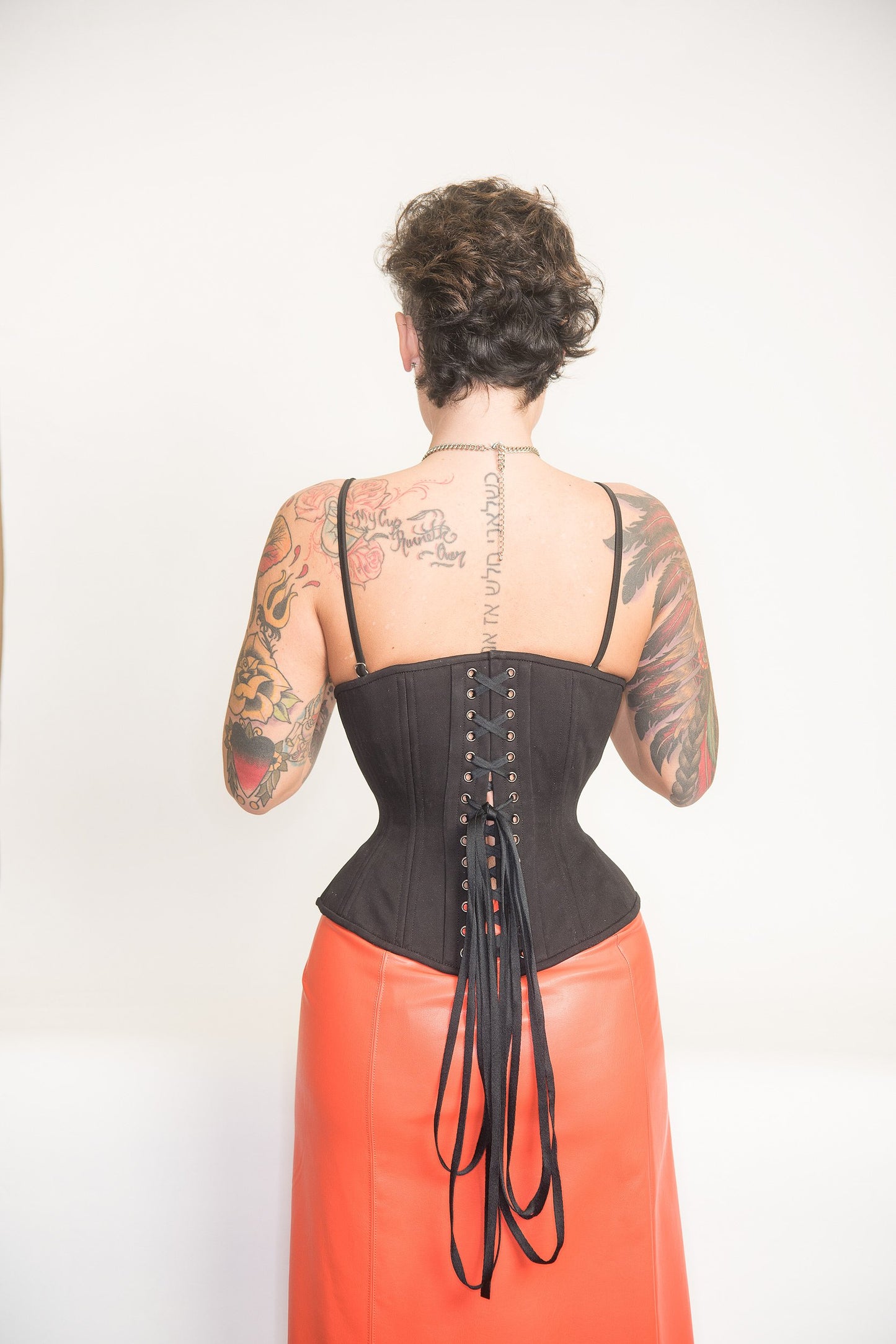 Black Cotton corset, Libra silhouette, regular underbust length, back view on a model, laced fully closed