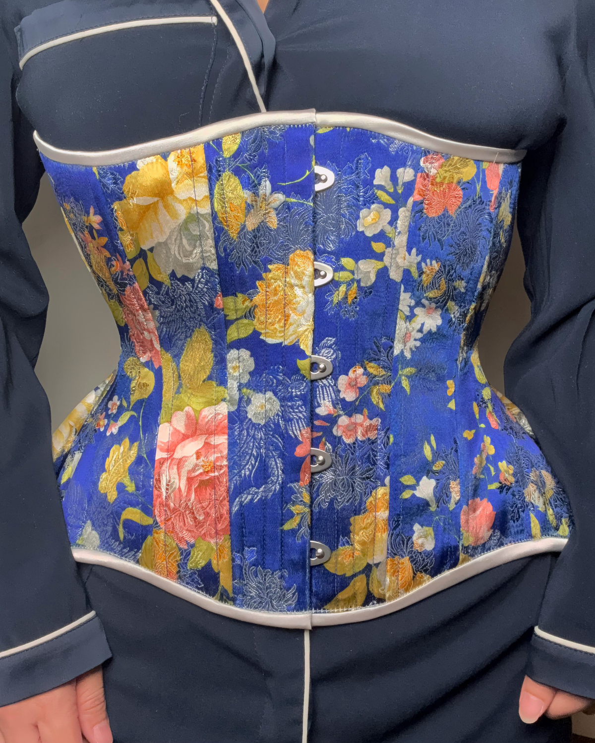 Evening Gardens Corset, curvy Gemini cupped rib Silhouette, Regular underbust length, worn by Hannah who modeled it with a blue silk shirt.